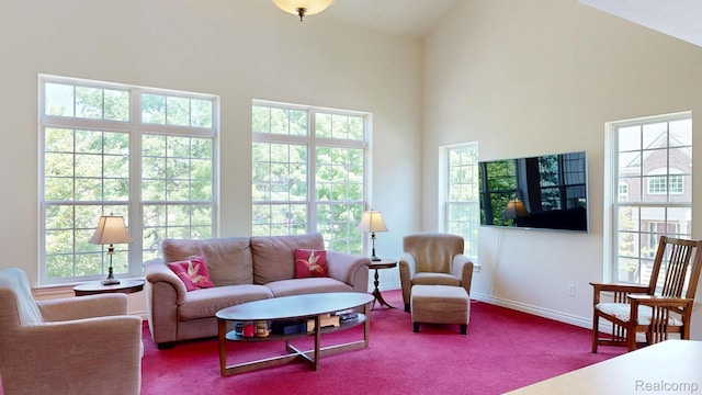 71 Grandview Cir, White Lake, MI 48386 - carpeted living area featuring healthy amount of natural light, a high ceiling, and baseboards