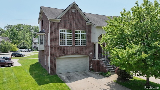 71 Grandview Cir, White Lake, MI 48386 - view of front facade with brick siding, driveway, a garage, and a front yard