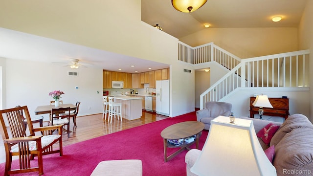 71 Grandview Cir, White Lake, MI 48386 - living area with a ceiling fan, stairs, wood finished floors, and lofted ceiling