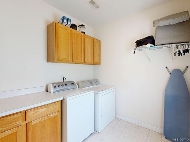 71 Grandview Cir, White Lake, MI 48386 - washroom featuring cabinet space, separate washer and dryer, baseboards, and light tile patterned floors