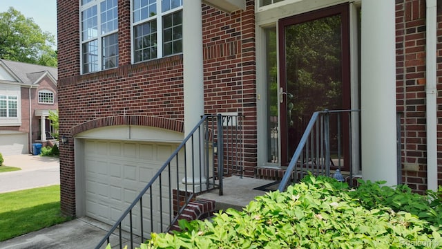 71 Grandview Cir, White Lake, MI 48386 - property entrance with brick siding, an attached garage, and concrete driveway
