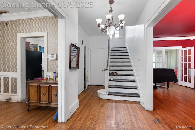 1475 Atkinson St, Detroit, MI 48206 - staircase with hardwood / wood-style flooring, baseboards, plenty of natural light, a chandelier, and wallpapered walls