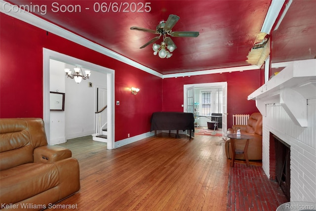 1475 Atkinson St, Detroit, MI 48206 - living area with a fireplace, stairs, hardwood / wood-style flooring, radiator, and a ceiling fan