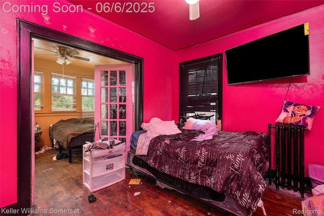 1475 Atkinson St, Detroit, MI 48206 - bedroom with radiator, wood-type flooring, and a ceiling fan