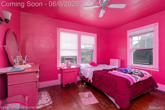 1475 Atkinson St, Detroit, MI 48206 - bedroom featuring radiator heating unit, wood finished floors, multiple windows, and baseboards