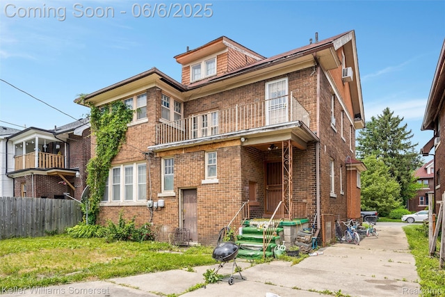 1475 Atkinson St, Detroit, MI 48206 - view of front facade with a balcony and brick siding