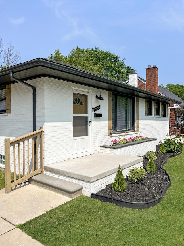 20215 Damman St, Harper Woods, MI 48225 - view of front of property featuring brick siding, a chimney, a front yard, and a porch