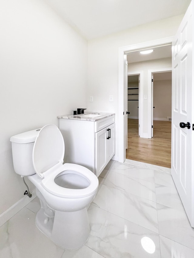 20215 Damman St, Harper Woods, MI 48225 - half bathroom featuring baseboards, toilet, marble finish floors, and vanity