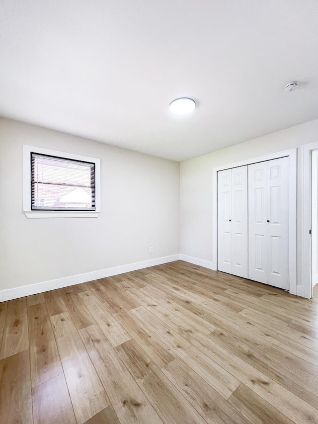 20215 Damman St, Harper Woods, MI 48225 - unfurnished bedroom with light wood-style flooring, a closet, and baseboards
