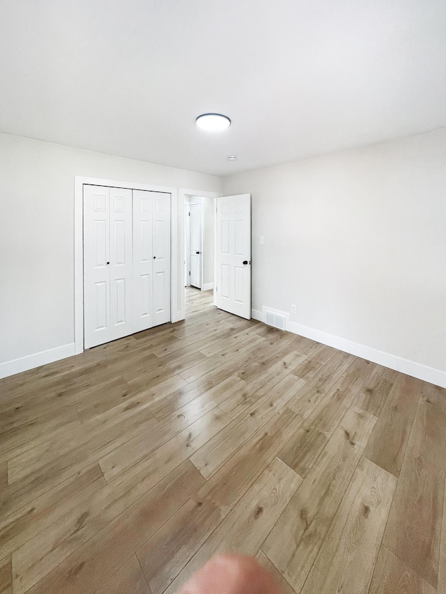 20215 Damman St, Harper Woods, MI 48225 - unfurnished bedroom featuring light wood-style flooring, baseboards, and a closet