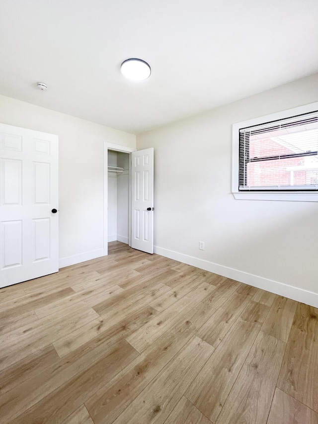 20215 Damman St, Harper Woods, MI 48225 - unfurnished bedroom featuring light wood finished floors, baseboards, and a closet