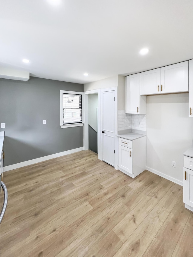 20215 Damman St, Harper Woods, MI 48225 - kitchen with white cabinetry, light wood-style floors, backsplash, recessed lighting, and light countertops