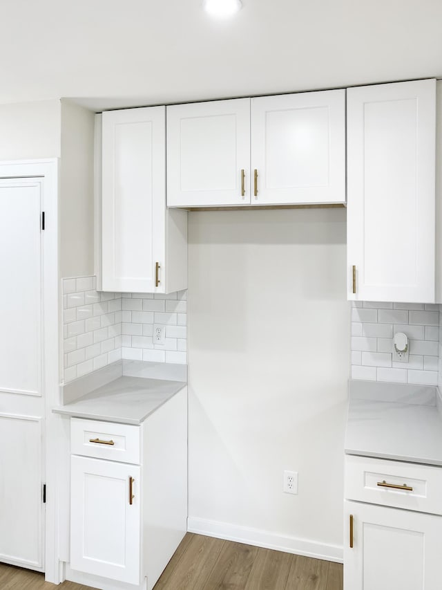 20215 Damman St, Harper Woods, MI 48225 - kitchen featuring light countertops, white cabinets, and decorative backsplash