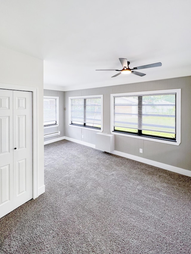 20215 Damman St, Harper Woods, MI 48225 - spare room with dark carpet, baseboards, and a ceiling fan