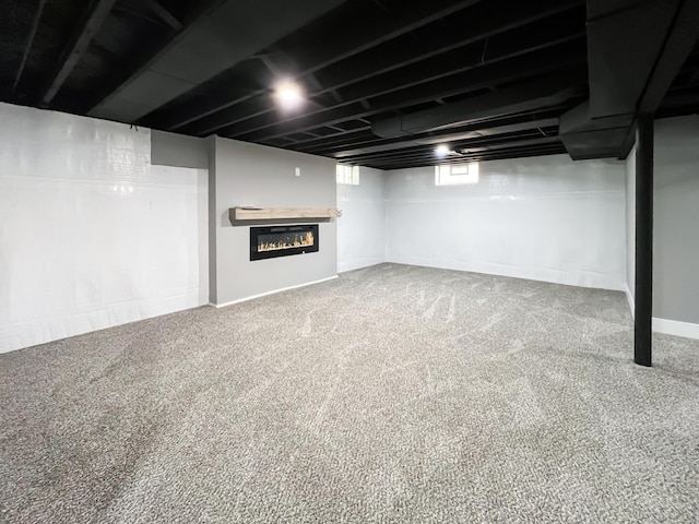 20215 Damman St, Harper Woods, MI 48225 - below grade area featuring carpet floors, a glass covered fireplace, and baseboards
