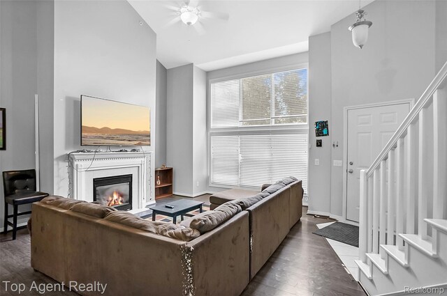 11685 Squiers Blvd, Utica, MI 48315 - living area with stairway, wood finished floors, ceiling fan, and a glass covered fireplace