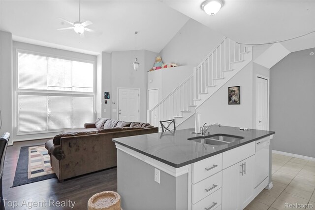 11685 Squiers Blvd, Utica, MI 48315 - kitchen featuring a ceiling fan, dark countertops, white cabinets, vaulted ceiling, and hanging light fixtures