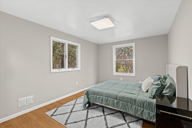 2128 Somerset Rd, Bloomfield Hills, MI 48302 - bedroom with multiple windows, baseboards, and wood finished floors