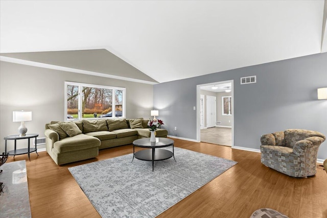 2128 Somerset Rd, Bloomfield Hills, MI 48302 - living room featuring vaulted ceiling, wood finished floors, and baseboards