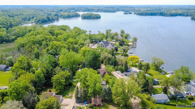 2650 Devonshire, Leonard, MI 48367 - aerial perspective of suburban area with a nearby body of water and a heavily wooded area