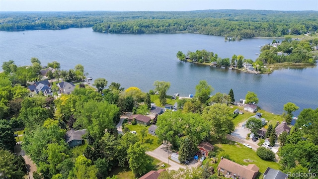 2650 Devonshire, Leonard, MI 48367 - aerial view of property and surrounding area with a forest, a nearby body of water, and nearby suburban area