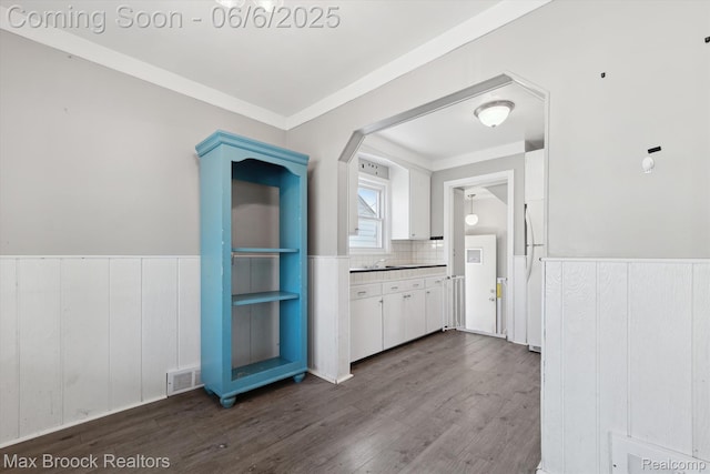 21426 Syracuse Ave, Warren, MI 48091 - kitchen with white cabinets, dark wood-style floors, wainscoting, ornamental molding, and decorative backsplash