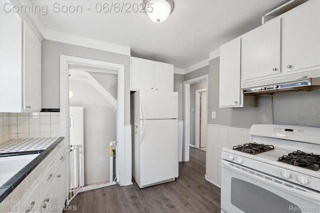 21426 Syracuse Ave, Warren, MI 48091 - kitchen with white appliances, under cabinet range hood, white cabinetry, and a wainscoted wall