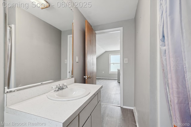 21426 Syracuse Ave, Warren, MI 48091 - bathroom featuring vanity, wood finished floors, vaulted ceiling, and baseboards