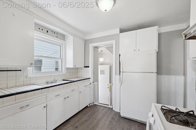 21426 Syracuse Ave, Warren, MI 48091 - kitchen with freestanding refrigerator, tile counters, white cabinetry, stove, and decorative backsplash