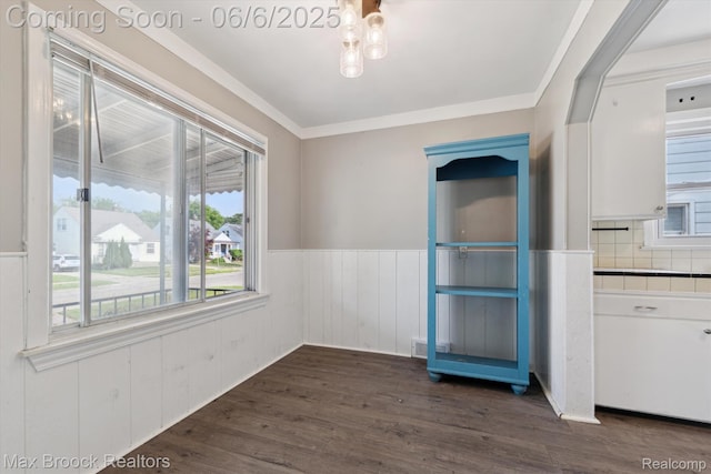 21426 Syracuse Ave, Warren, MI 48091 - unfurnished dining area with a wainscoted wall, dark wood-type flooring, and ornamental molding