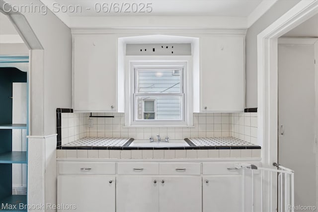 21426 Syracuse Ave, Warren, MI 48091 - kitchen with tile countertops, white cabinets, and a sink