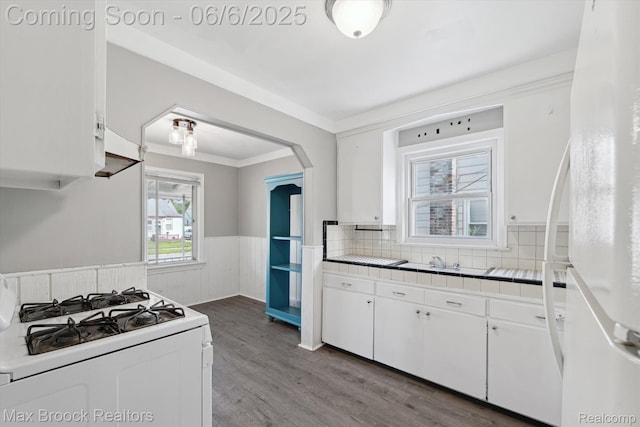 21426 Syracuse Ave, Warren, MI 48091 - kitchen featuring white appliances, tile countertops, wainscoting, white cabinetry, and wood finished floors