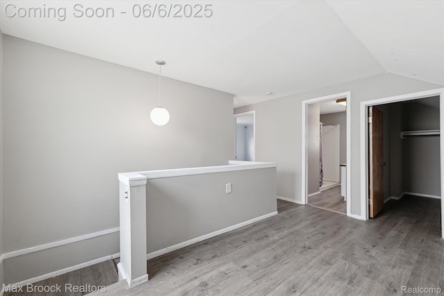 21426 Syracuse Ave, Warren, MI 48091 - interior space with wood finished floors, a walk in closet, vaulted ceiling, baseboards, and a closet