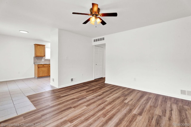244 E Woodward Heights Blvd, Hazel Park, MI 48030 - unfurnished room with a ceiling fan, light wood-type flooring, and baseboards