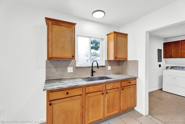 244 E Woodward Heights Blvd, Hazel Park, MI 48030 - kitchen with washer / dryer, a sink, tasteful backsplash, light stone countertops, and electric panel