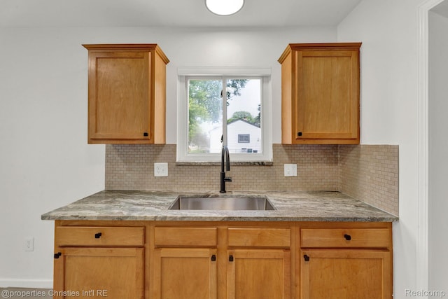244 E Woodward Heights Blvd, Hazel Park, MI 48030 - kitchen featuring a sink, backsplash, and light stone counters
