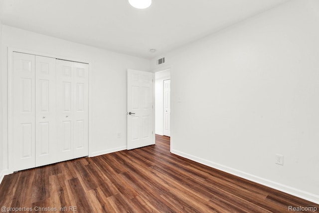 244 E Woodward Heights Blvd, Hazel Park, MI 48030 - unfurnished bedroom with dark wood-type flooring, baseboards, and a closet