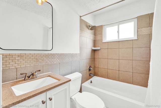 244 E Woodward Heights Blvd, Hazel Park, MI 48030 - full bath with shower / bath combo, toilet, tile walls, vanity, and a textured ceiling
