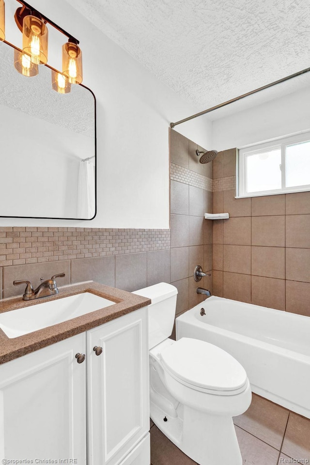 244 E Woodward Heights Blvd, Hazel Park, MI 48030 - full bathroom featuring a textured ceiling, tile walls, bathtub / shower combination, tile patterned flooring, and vanity