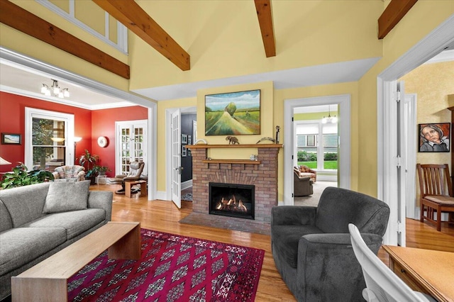 244 Paris Ave SE, Grand Rapids, MI 49503 - living area with a brick fireplace, wood finished floors, a chandelier, beam ceiling, and baseboards