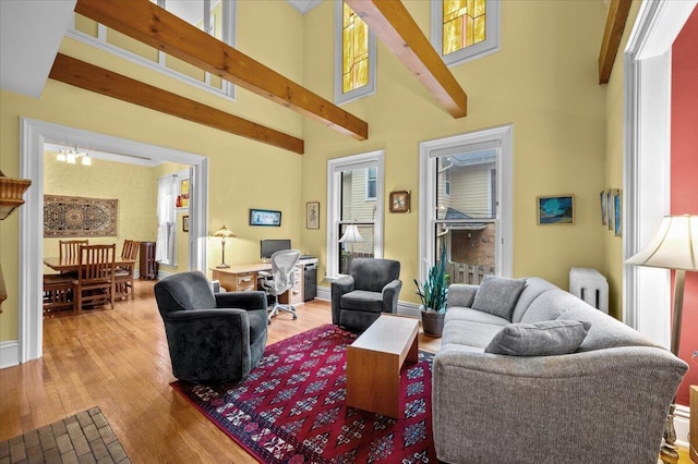 244 Paris Ave SE, Grand Rapids, MI 49503 - living room with wood finished floors, beam ceiling, a desk, and a towering ceiling