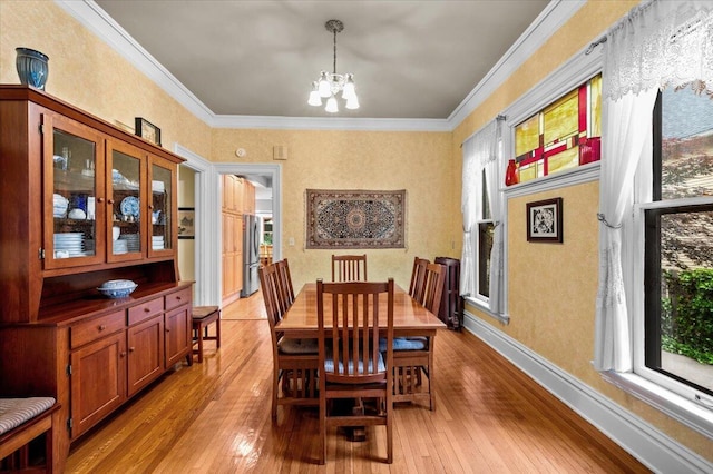 244 Paris Ave SE, Grand Rapids, MI 49503 - dining room featuring a chandelier, light wood-style floors, ornamental molding, and baseboards
