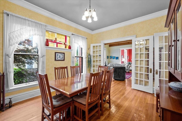 244 Paris Ave SE, Grand Rapids, MI 49503 - dining room featuring french doors, a chandelier, light wood-type flooring, crown molding, and baseboards