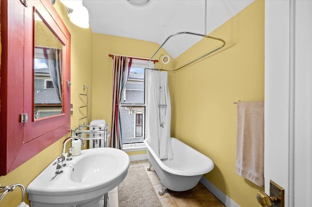 244 Paris Ave SE, Grand Rapids, MI 49503 - bathroom with a sink, tile patterned flooring, baseboards, and a shower with curtain