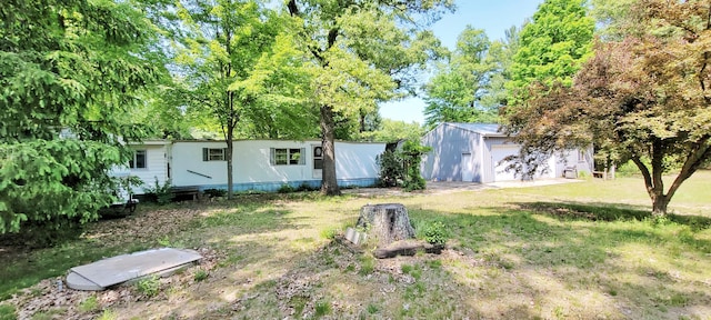 5350 E Crystal Lake Rd, Holton, MI 49425 - view of yard with an outbuilding and a garage