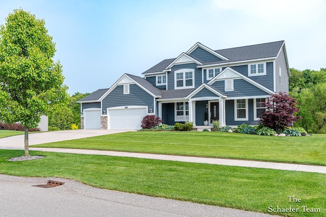 12150 Apple Cart Ln, Lowell, MI 49331 - craftsman inspired home featuring concrete driveway, a garage, covered porch, a front yard, and stone siding