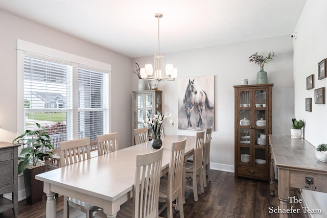 12150 Apple Cart Ln, Lowell, MI 49331 - dining area with dark wood-type flooring, a chandelier, and baseboards