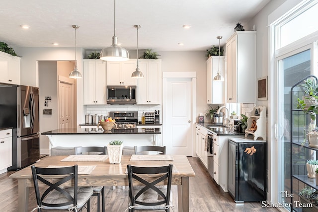 12150 Apple Cart Ln, Lowell, MI 49331 - kitchen with appliances with stainless steel finishes, dark countertops, a sink, tasteful backsplash, and recessed lighting