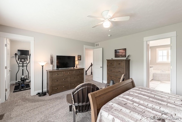 12150 Apple Cart Ln, Lowell, MI 49331 - carpeted bedroom featuring baseboards, ceiling fan, and ensuite bathroom