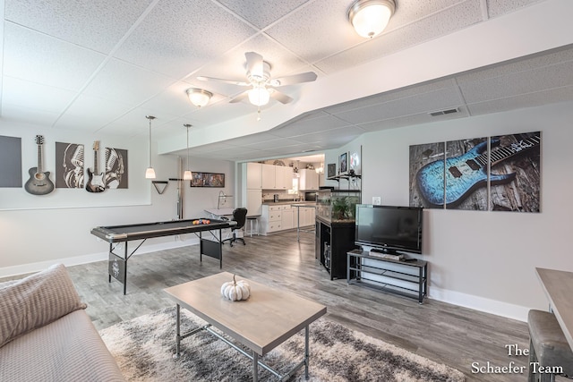 12150 Apple Cart Ln, Lowell, MI 49331 - living area with a paneled ceiling, light wood finished floors, baseboards, and a ceiling fan